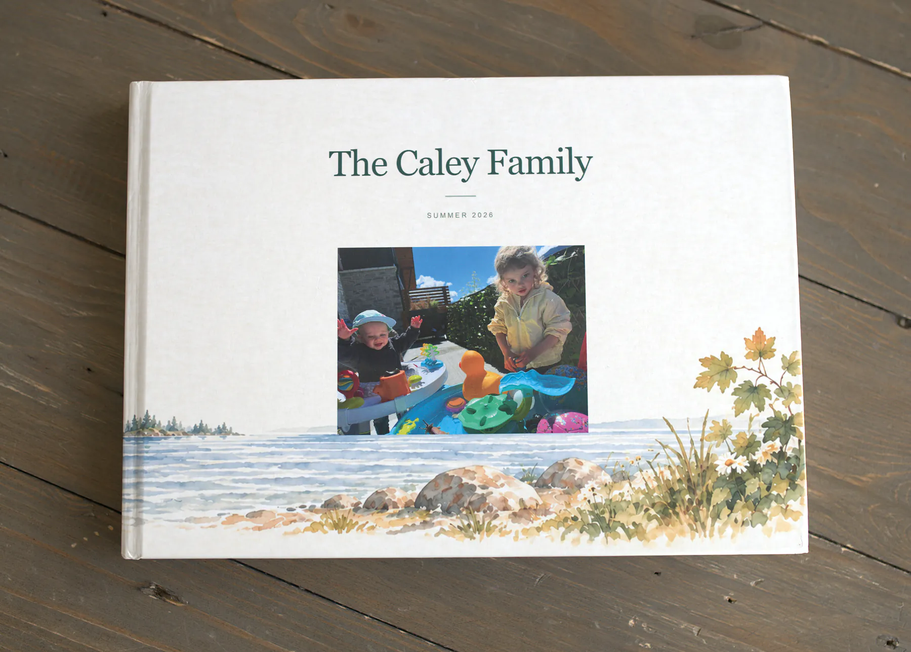 Nicole’s Tuck book: a hardcover with The Caley Family on the cover, lying on the wood floor at home.